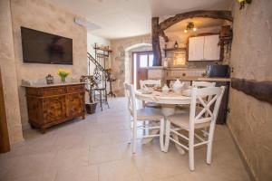 a kitchen and dining room with a table and chairs at Rustic-Holiday Home Vani with Tavern, near Porec in Nova Vas