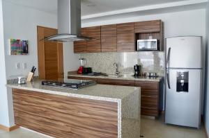 a kitchen with a refrigerator and a counter top at Metropolitan Suites in Guadalajara