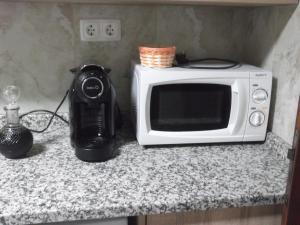 a microwave sitting on a counter next to a blender at Casa da Avó in Castelo de Vide