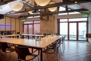 a large dining room with a long table and chairs at Koljunuki sadam "Veer" accommodation in Ülgase