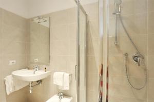 a bathroom with a shower and a sink at Tornabuoni Boutique in Florence