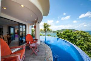 a villa with a swimming pool with a view of the ocean at Villa Noche in San Juan del Sur