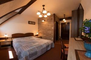 a bedroom with a bed and a brick wall at Família Vendégház in Szeged