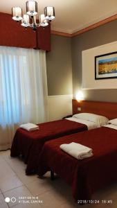 Кровать или кровати в номере Hotel Minerva