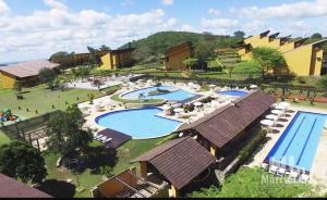 an aerial view of a resort with two swimming pools at Winterville Gravatá Alpes Suiços in Gravatá