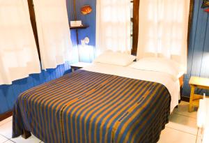 Postel nebo postele na pokoji v ubytování Bananarama Dive & Beach Resort