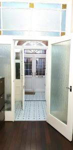 a room with a white door and a tile floor at Gabriel Guesthouse in Rhyl