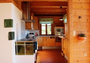 a large kitchen with wooden cabinets and a window at Traunsee-Traum in Grasberg