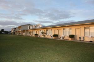 a large building with a lawn in front of it at Lakeview Motel and Apartments in Robe