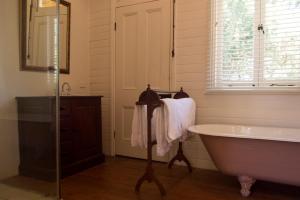 a white bath tub sitting next to a window at Hillview Heritage Estate in Sutton Forest