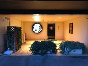 a front porch of a house with a wreath on the wall at Hotel Gaudium (Adult Only) in Kuki +9 photos
