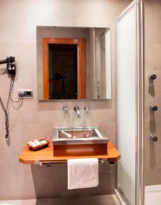 a bathroom with a sink and a shower at Hospedium Hotel Posada De La Luna in Huesca +37 photos