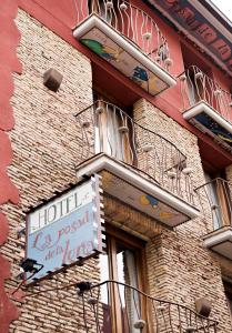 a building with a sign on the side of it at Hospedium Hotel Posada De La Luna in Huesca