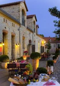 a table with food on it in front of a building at Hotel Burg Wanzleben in Wanzleben