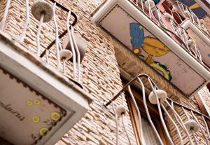 a wall with clocks and hangers on it at Hospedium Hotel Posada De La Luna in Huesca