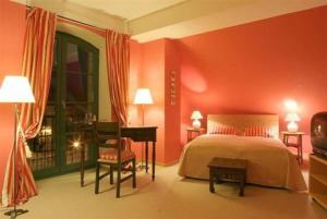 a bedroom with red walls and a bed and a piano at Hotel Burg Wanzleben in Wanzleben