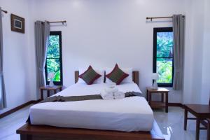 Postel nebo postele na pokoji v ubytování Chanapha Residence