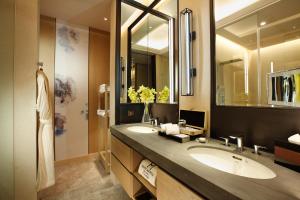 a bathroom with two sinks and a large mirror at Grand Mayfull Taipei in Taipei