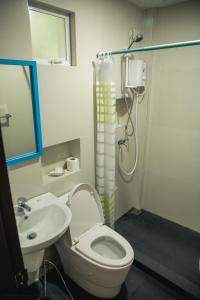 a bathroom with a shower and a toilet and a sink at Stunning Republic in El Nido