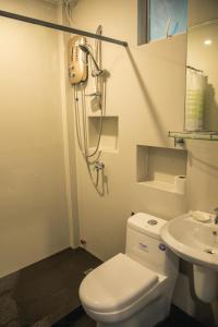 a bathroom with a toilet and a sink at Stunning Republic in El Nido