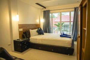 a bedroom with a large bed and a window at Stunning Republic in El Nido