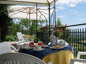 a table with a blue table cloth with food on it at Hotel Sangallo B&B - panoramic position - Valley and vineyard view- family run in Montepulciano