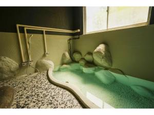 Krevet ili kreveti u jedinici u okviru objekta Onsen Yado Mizuguchi