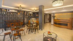 a restaurant with tables and chairs and a bar at V One Pride-Sukhumvit 22, Bangkok in Bangkok