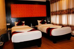 Voodi või voodid majutusasutuse Kathmandu Regency Hotel toas