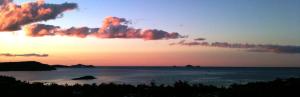 a large body of water with a sunset at Yachtsmans Paradise, Whitsundays in Airlie Beach