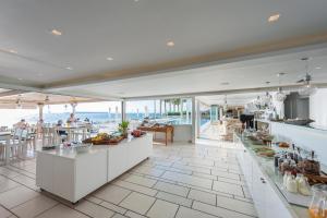a restaurant with a view of the ocean at Saint George Hotel in Chrissi Akti