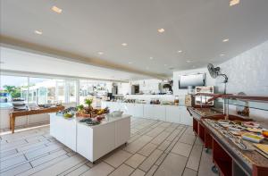 a large kitchen with a lot of food on display at Saint George Hotel in Chrissi Akti