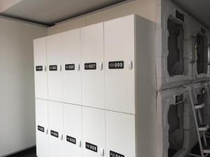 a row of white lockers in a room at Pod Inn in Launceston