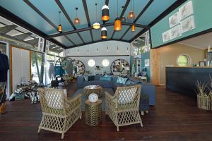 a living room with a blue couch and chairs at Zambezi Mubala Lodge in Katima Mulilo