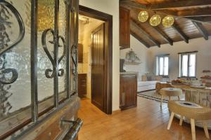 a kitchen and living room with a table and chairs at Agkaze in Palaios Panteleimonas +2 photos