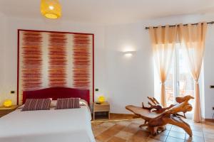 a bedroom with a white bed and a large window at Vista Mare B&B in Sorrento