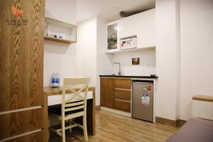 a small kitchen with a desk and a chair at V House 5 Serviced Apartment in Hanoi