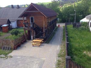 a log cabin with a bench and a porch at хостел "Трутень" in Vorokhta