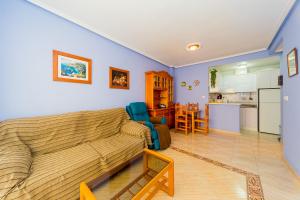 a living room with a couch and a kitchen at ALEGRIA ID118 in Torrevieja