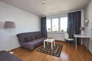 a living room with a couch and a table at Top Ten House Marszałkowska I in Warsaw