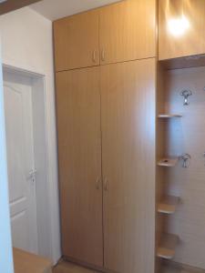a closet with wooden cabinets in a room at Bisa in Soko Banja