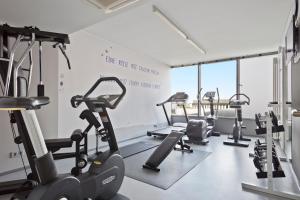 a gym with treadmills and ellipticals in a room at INNSiDE by Meliá München Parkstadt Schwabing in Munich
