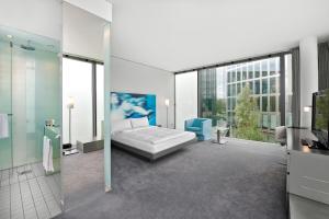 a large bathroom with a bed and a shower at INNSiDE by Meliá München Parkstadt Schwabing in Munich