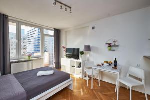 a bedroom with a bed and a table with chairs at Top Ten House Marszałkowska III in Warsaw