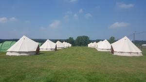 een rij witte tenten in een veld bij IntentsGP @ Spa-Francorchamps F1 in Francorchamps