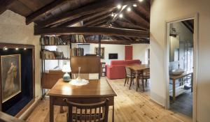 a living room with a table and a dining room at D'Orsaria B&B And Wines in Premariacco