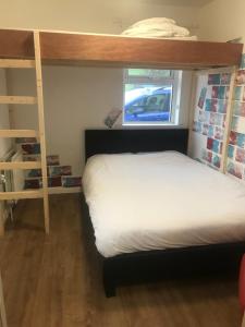 a bedroom with two bunk beds and a window at Finn McCools Giants Causeway Hostel in Bushmills