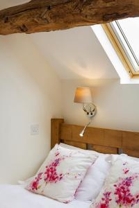 
a bedroom with a white bed and a white wall at Unit 1 Dove Farm Barns in Stoke on Trent
