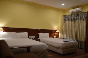 Ліжко або ліжка в номері Hotel The White Lotus View Pvt Ltd