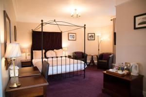 a hotel room with a bed and a desk and chair at Bedford Hotel in Tavistock
